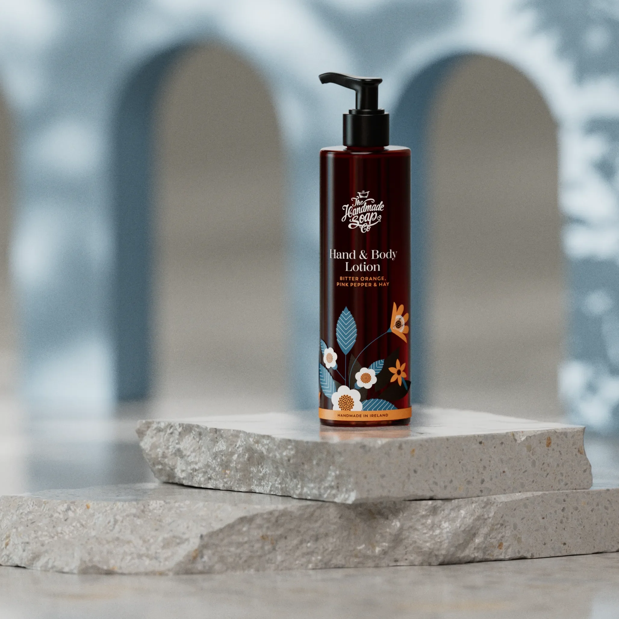 Flasche der Bitter Orange & Pink Pepper Bodylotion 250 ml von The Handmade Soap Company auf hellem Hintergrund