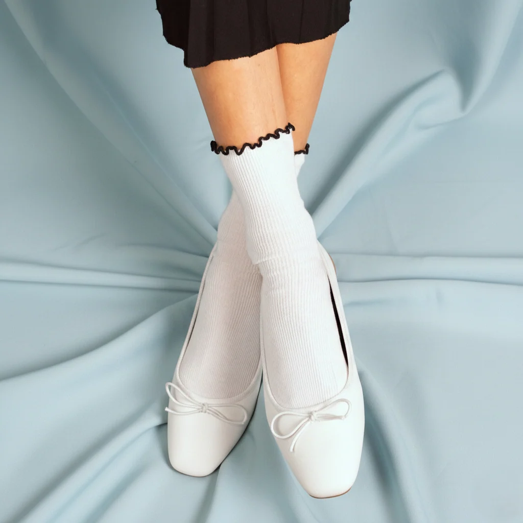 Schwarze Rüschensocken von KLUE aus Bio-Baumwolle mit feinem gewelltem Rüschenabschluss am Knöchel.