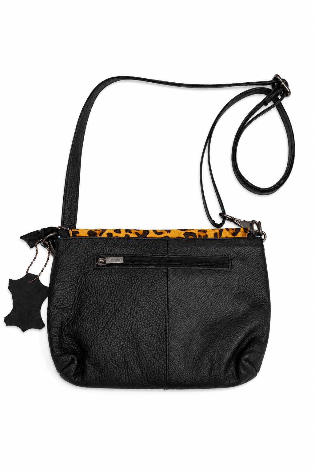 schwarze Handtasche von Soruka mit Klappe aus Kuhfell in Leo Optik. Rückansicht.